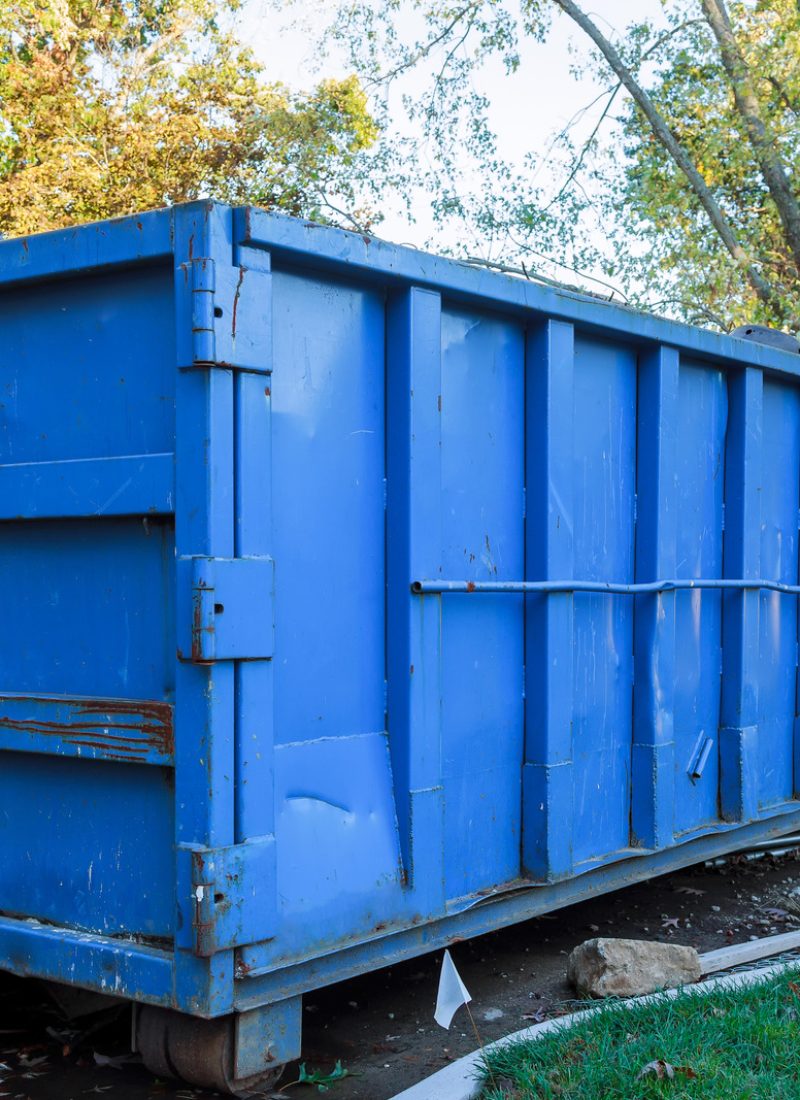 Loaded dumpster near a construction site, home renovation dumpster filled with building rubble dumpster